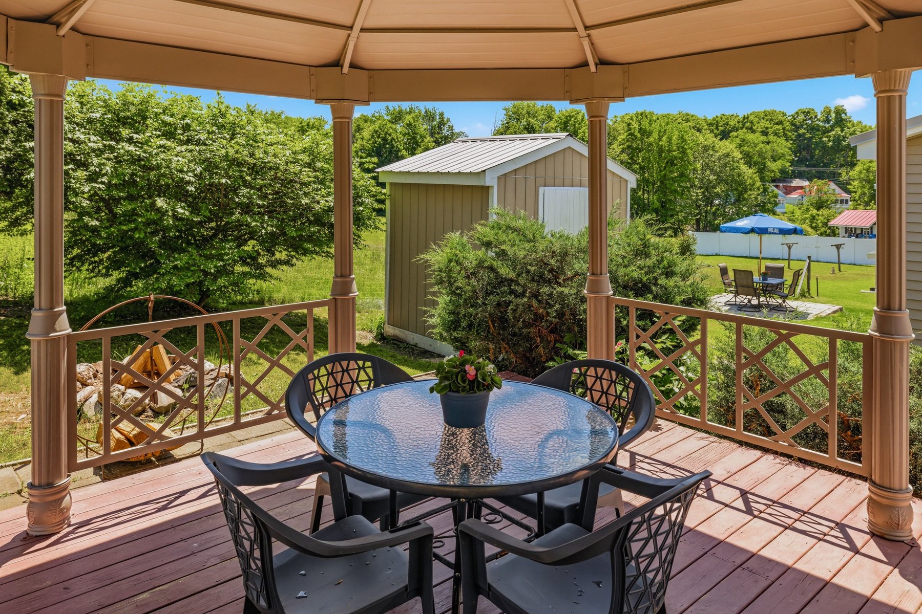 Inside the gazebo, looking out across the deck toward the shed and yard