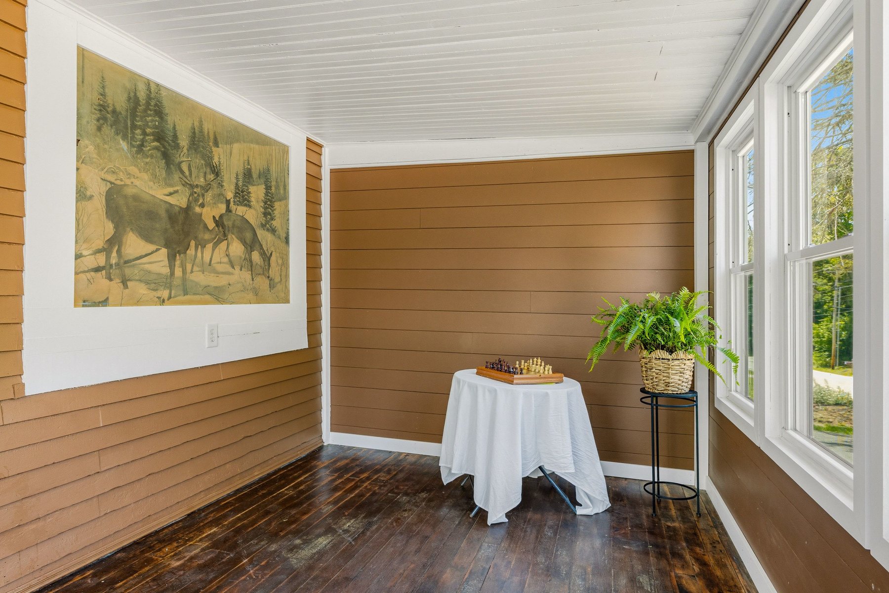 Enclosed porch with the original 1925 exterior wall left exposed beside the windows