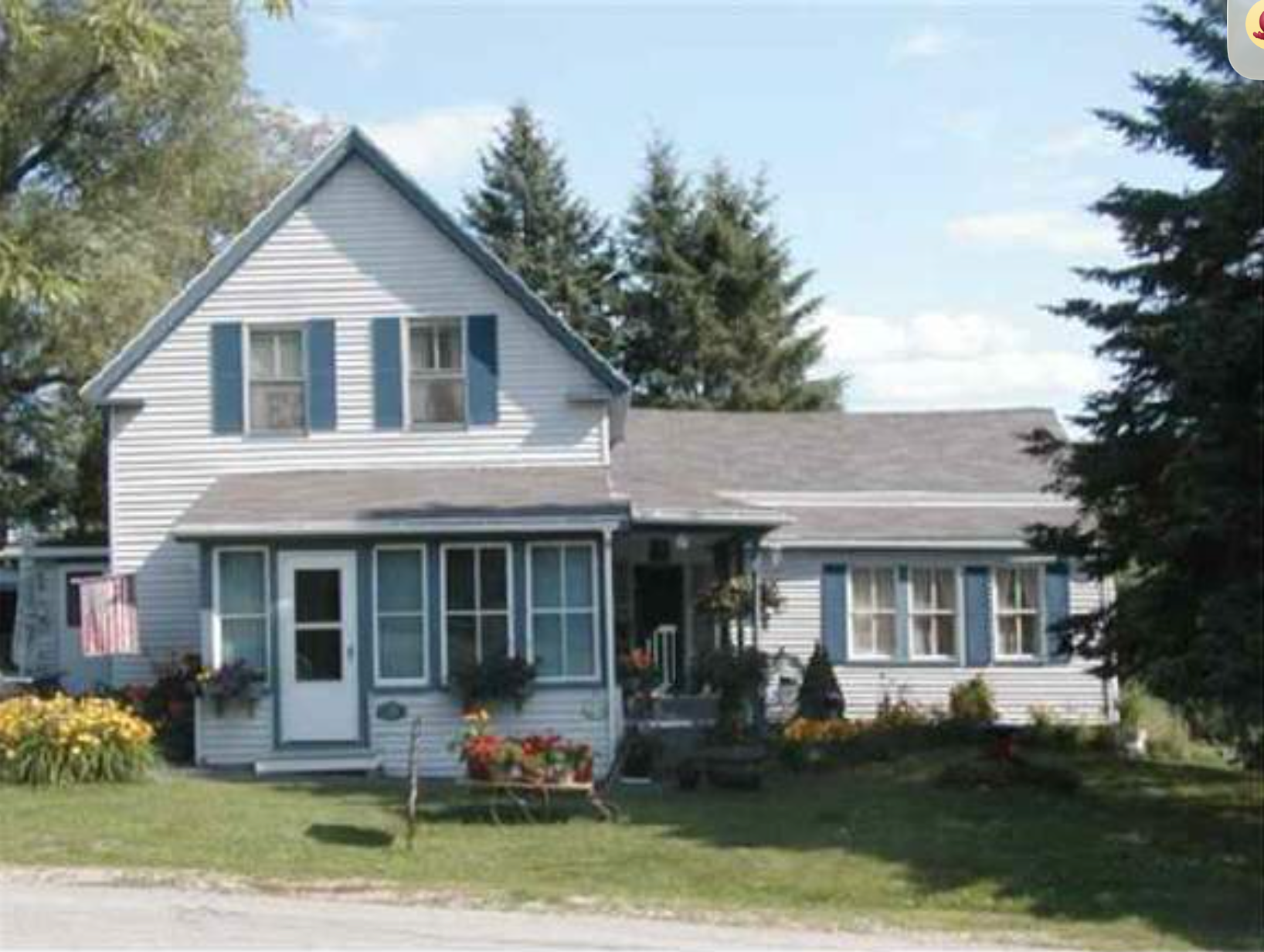 25 Mill Street before its renovation, the original 1925 farmhouse with weathered blue siding and the small in-law wing